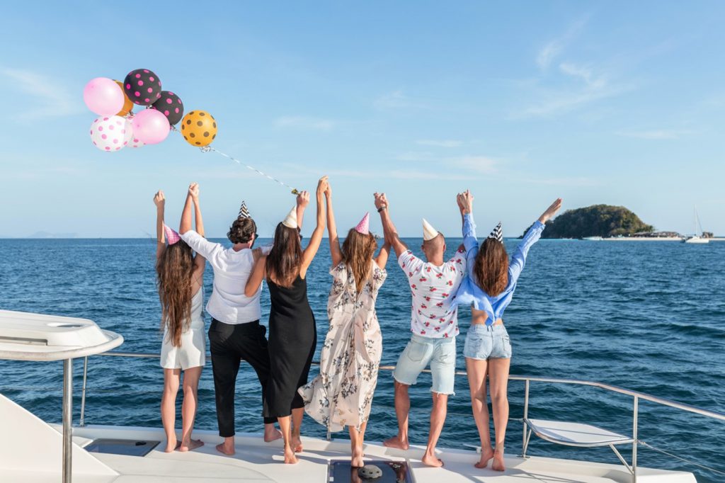 A vibrant boat party in Sydney with panoramic harbor views.